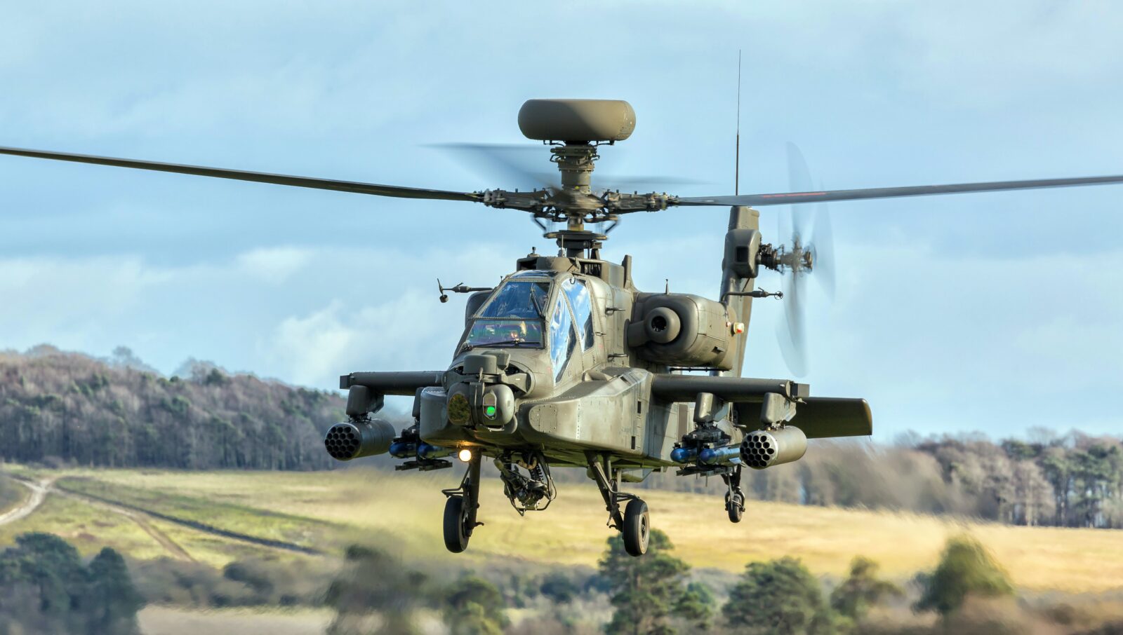 Military helicopter flying over countryside