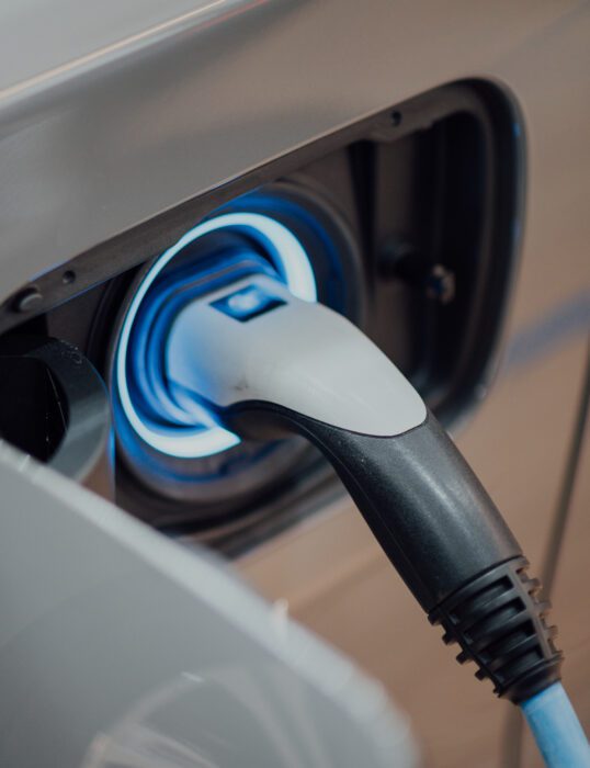 An electric vehicle charger plugged into a car
